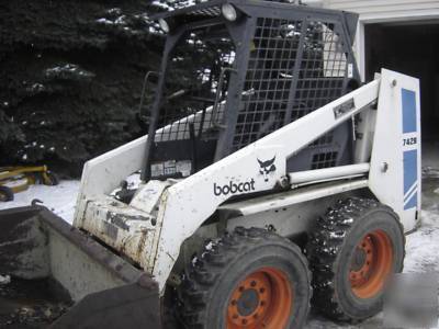Bobcat 742 b with backhoe and auger