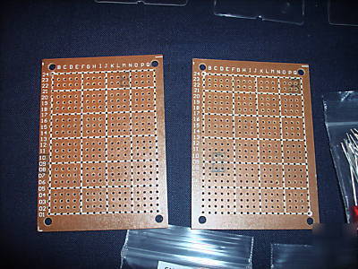 Assorted resistors, heat shrink, leds, pcb in a box