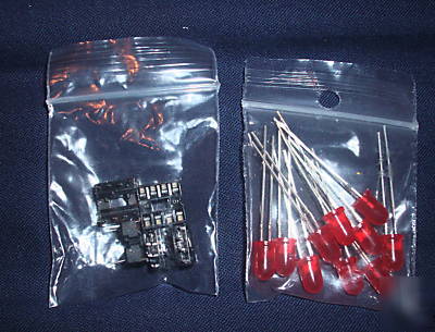 Assorted resistors, heat shrink, leds, pcb in a box