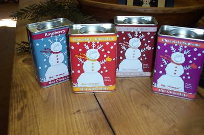 Four tins of snowman hot chocolate mix