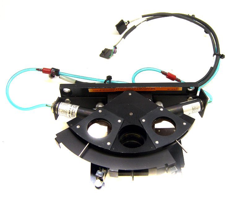 New port laser optical lens positioner rocking assembly